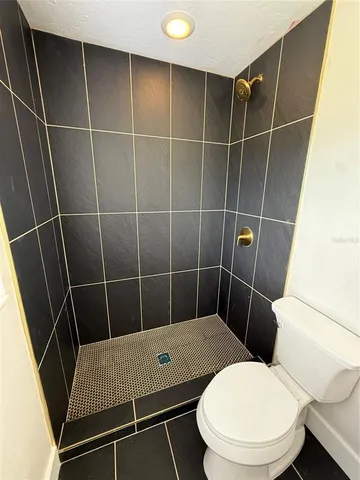 a bathroom with a toilet and a shower