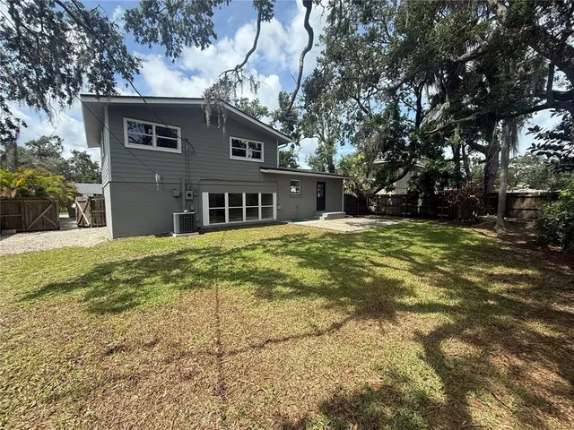 a house that has a tree in front of it