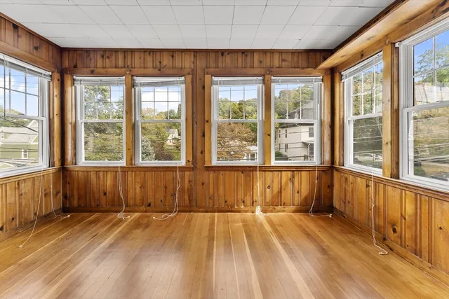 a view of a room with wooden floor and furniture