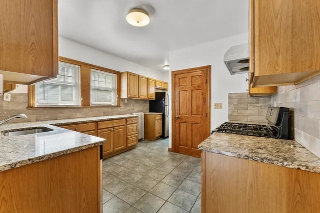a kitchen with a stove a sink and a refrigerator