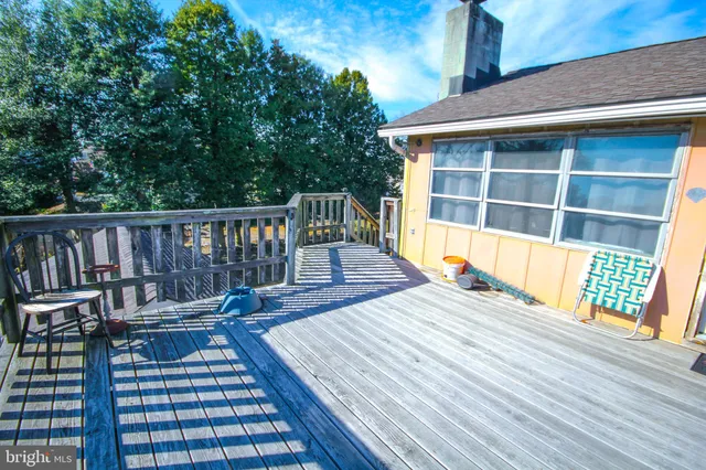 a view of balcony with wooden floor and outdoor seating