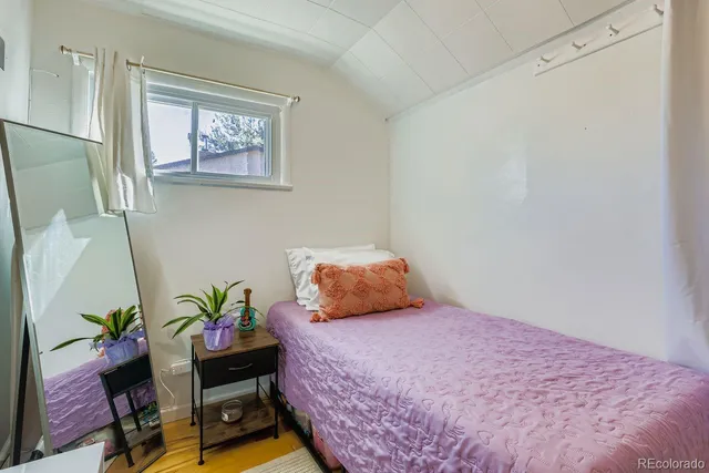 a bedroom with a bed and a bookshelf