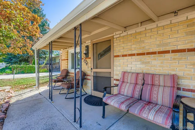 a outdoor living space with patio furniture and garden view