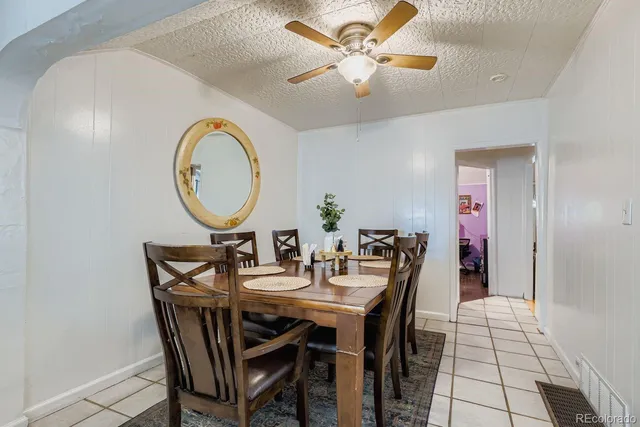 a dining room with furniture and a chandelier