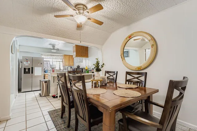 a view of a dining room with furniture and a chandelier