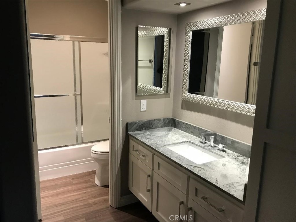5945 Armaga Spring Road, Unit B Rancho Palos Verdes, CA 90275 - Photo 8 of 11 a bathroom with a granite countertop sink toilet and shower curtains