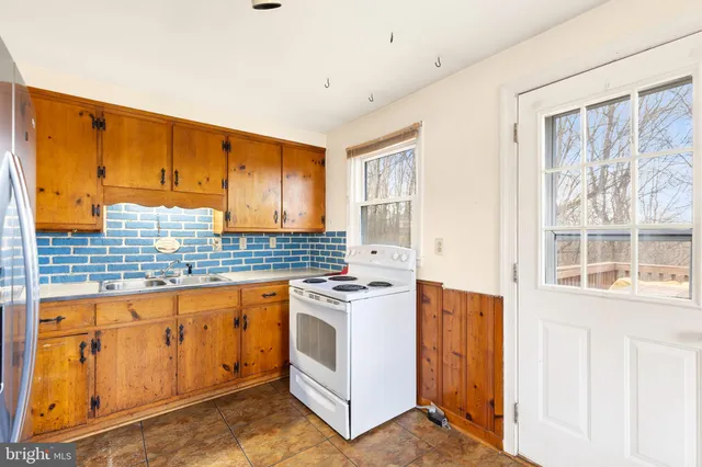 a kitchen with stainless steel appliances granite countertop a stove and a sink