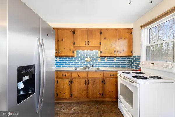a kitchen with stainless steel appliances granite countertop a stove and a refrigerator