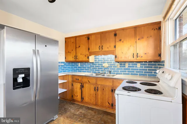 a kitchen with a refrigerator a stove and a sink