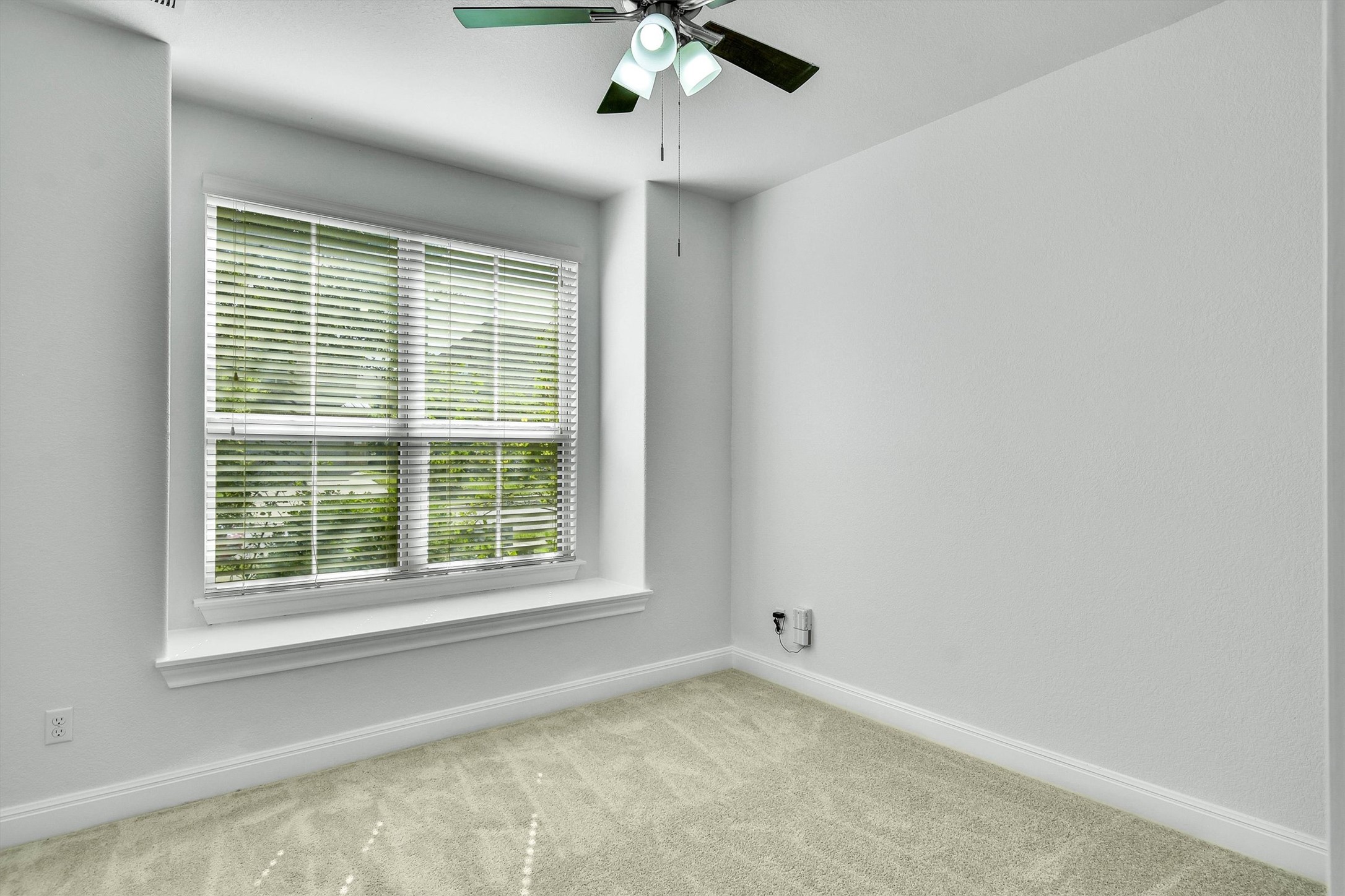 2325 Blended Tree Ranch Drive Leander, TX 78641 - Photo 22 of 35 A well-lit bedroom with fresh carpeting and a bright window.