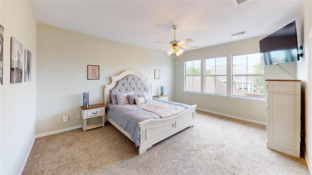 1747 Ivy Lane Carrollton, TX 75007 - Photo 12 of 21 a bed room with a bed and a chandelier