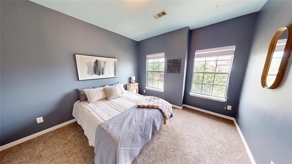 1747 Ivy Lane Carrollton, TX 75007 - Photo 16 of 21 a bed sitting in a bedroom next to a window