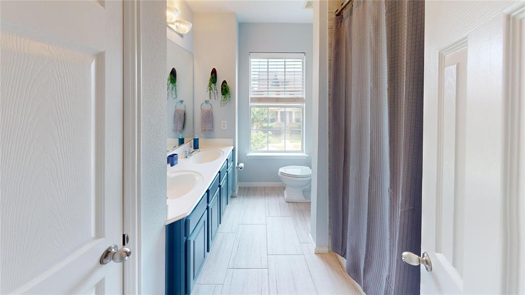 1747 Ivy Lane Carrollton, TX 75007 - Photo 17 of 21 a bathroom with a sink a toilet and shower