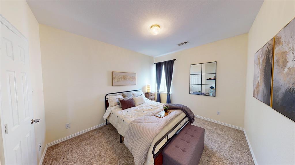 1747 Ivy Lane Carrollton, TX 75007 - Photo 19 of 21 a bedroom with a bed and a painting on the wall