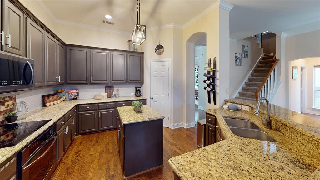 1747 Ivy Lane Carrollton, TX 75007 - Photo 7 of 21 a kitchen with wooden cabinets and sink