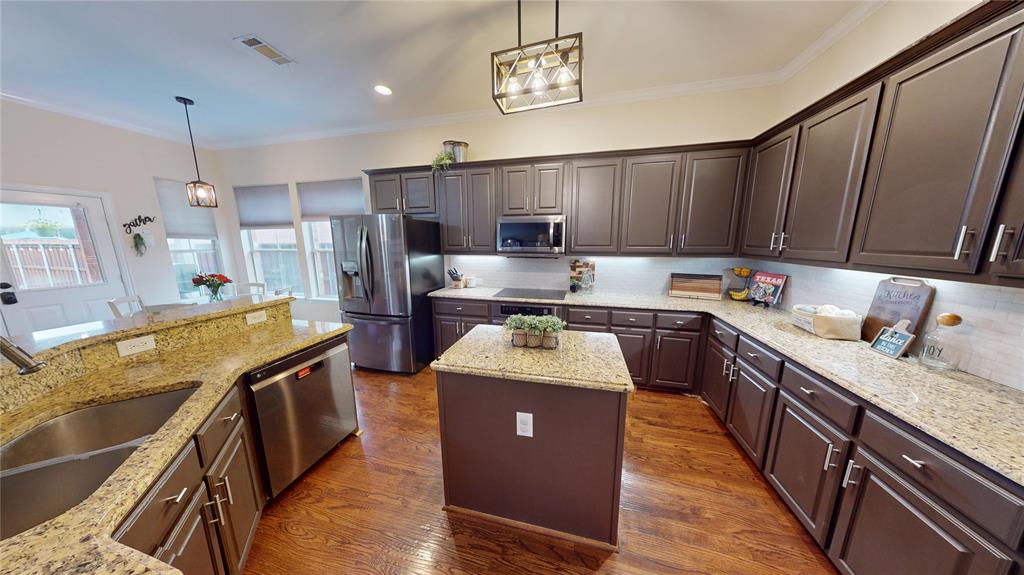1747 Ivy Lane Carrollton, TX 75007 - Photo 9 of 21 a kitchen with stainless steel appliances granite countertop a sink a stove and a refrigerator