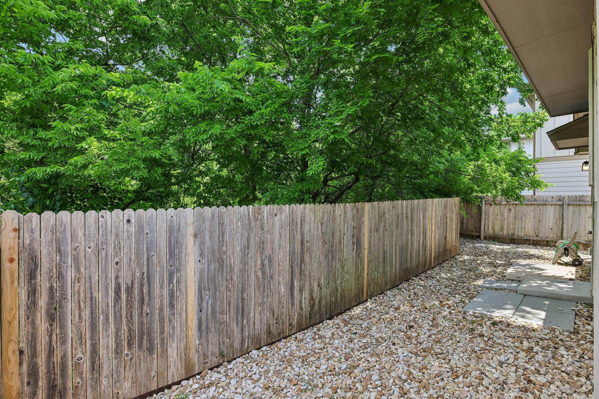 808 Totis Road Austin, TX 78748 - Photo 35 of 40 Private outdoor space featuring a wood privacy fence, gravel ground cover, and stepping stones