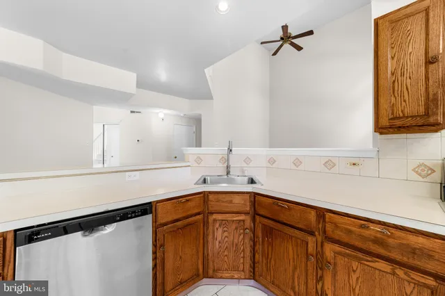 a kitchen with a sink a refrigerator and cabinets