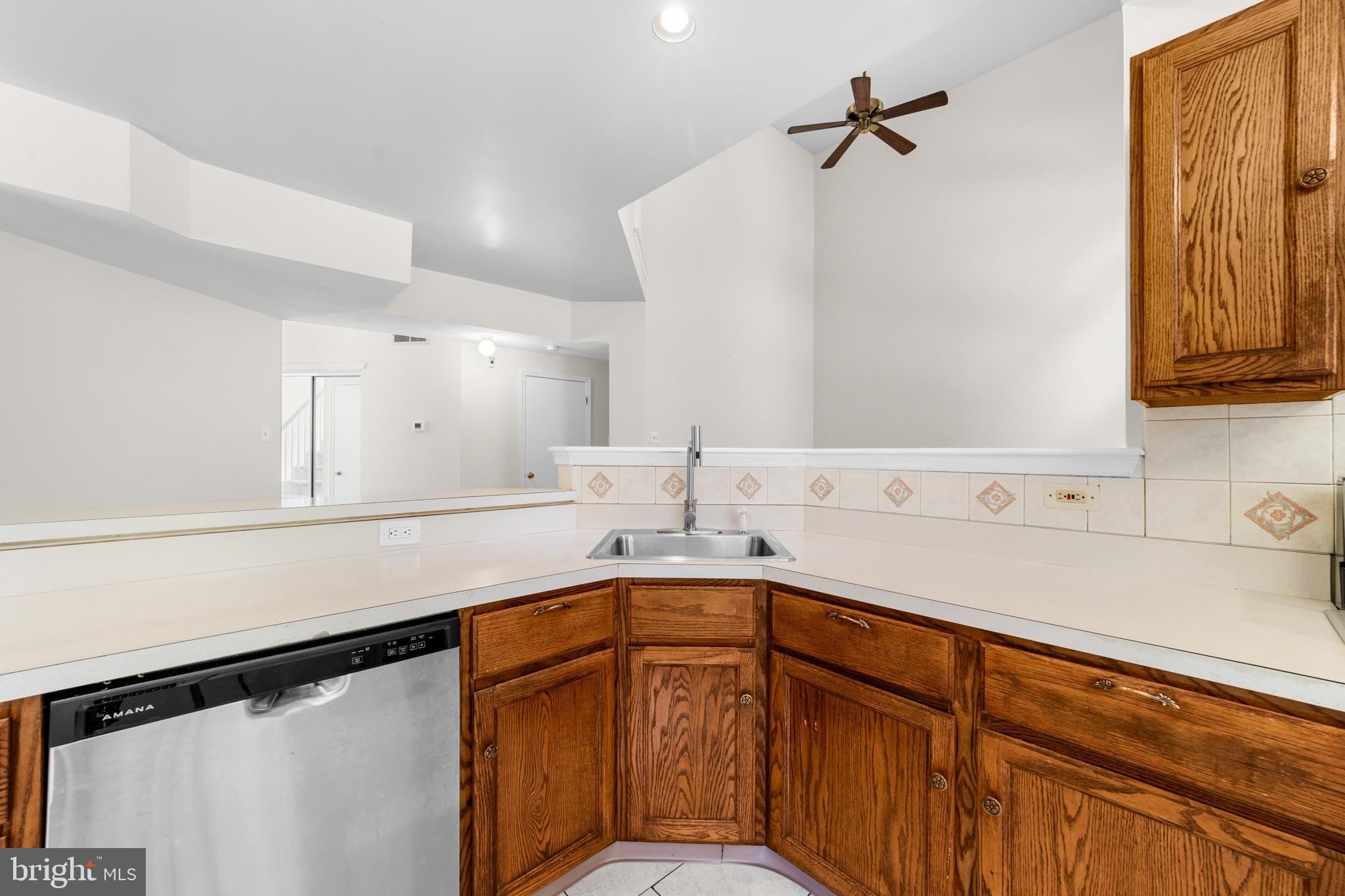 50 Wildcat Branch Drive Sicklerville, NJ 08081 - Photo 12 of 33 a kitchen with a sink a refrigerator and cabinets