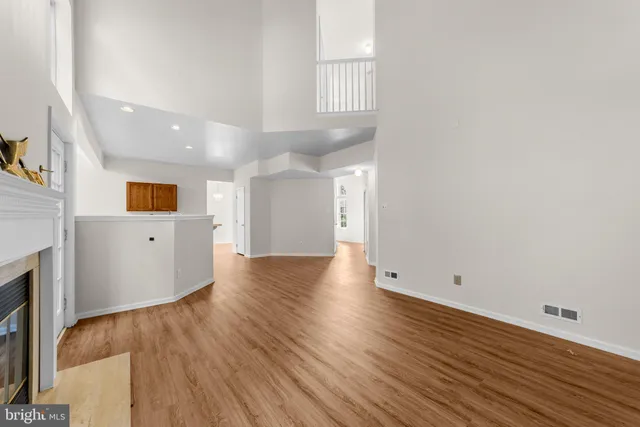 a view of a kitchen with wooden floor and a window