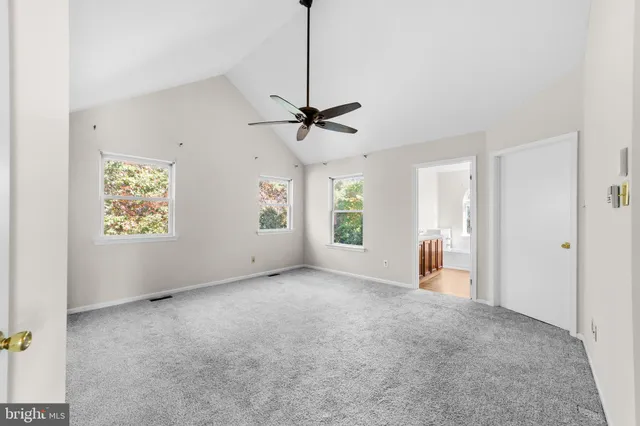 a view of a livingroom with a window and a ceiling fan