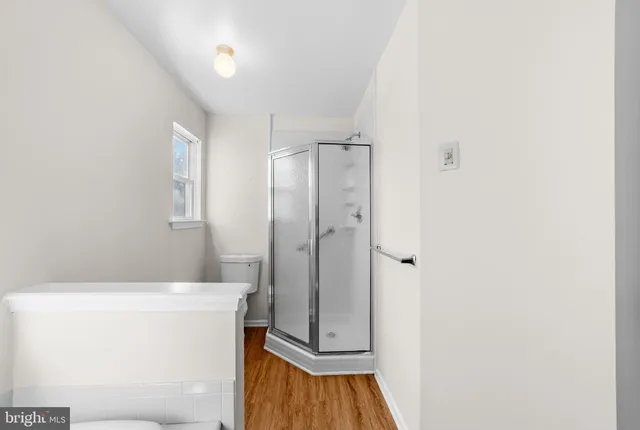 a bathroom with a shower and a sink