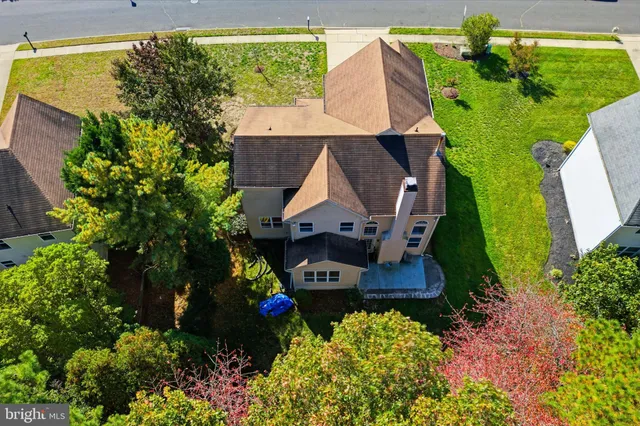 an aerial view of a house with a yard basket ball court and outdoor seating