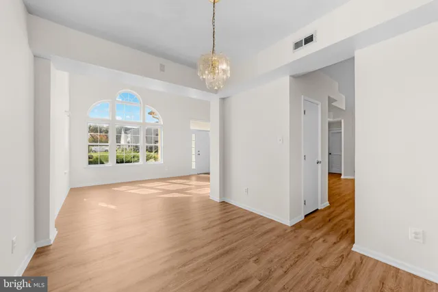 a view of livingroom with furniture wooden floor mirror and window
