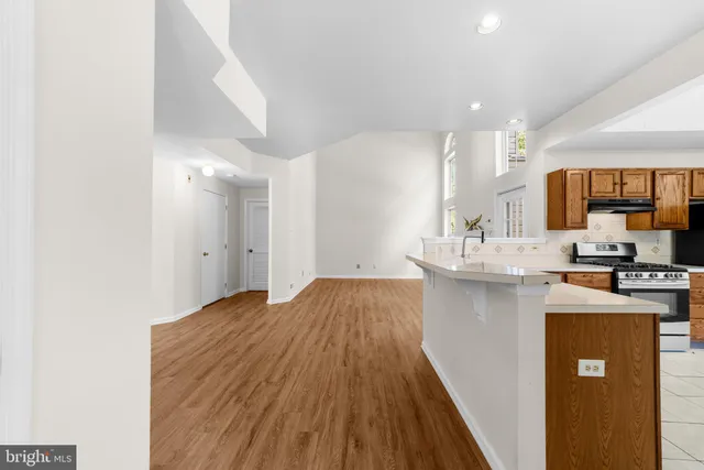 a kitchen with kitchen island a sink stove and refrigerator