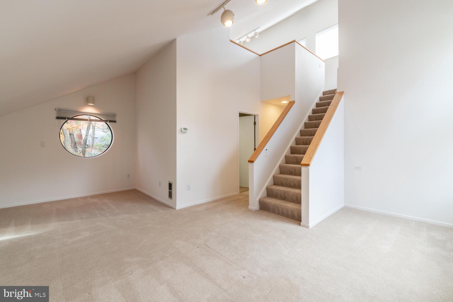 2100 South Bay Lane Reston, VA 20191 - Photo 32 of 43 Bonus Room with Round Window and Staircase to Loft