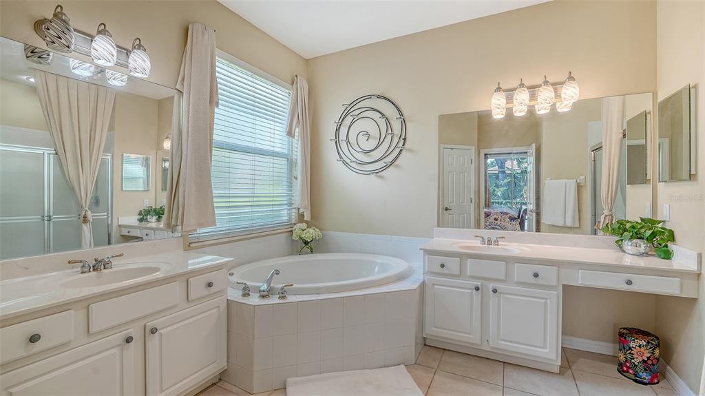 7717 US Open Loop Lakewood Ranch, FL 34202 - Photo 21 of 95 a bathroom with a granite countertop sink and a mirror