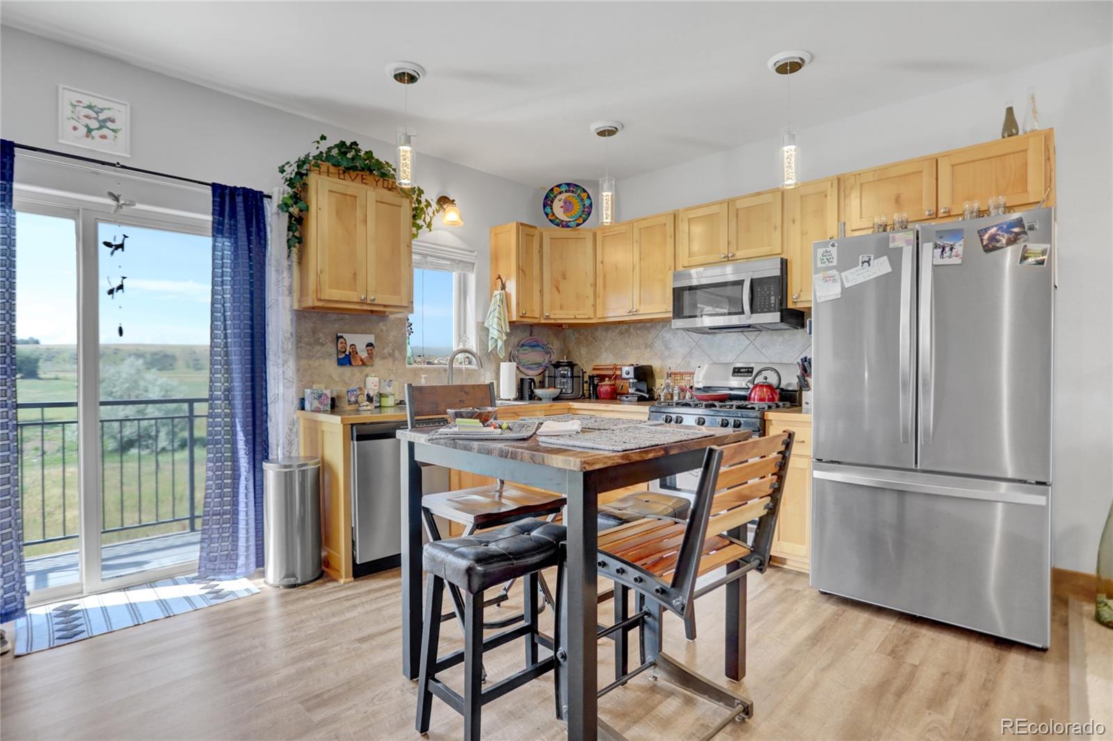 a kitchen with stainless steel appliances granite countertop a refrigerator and a stove top oven