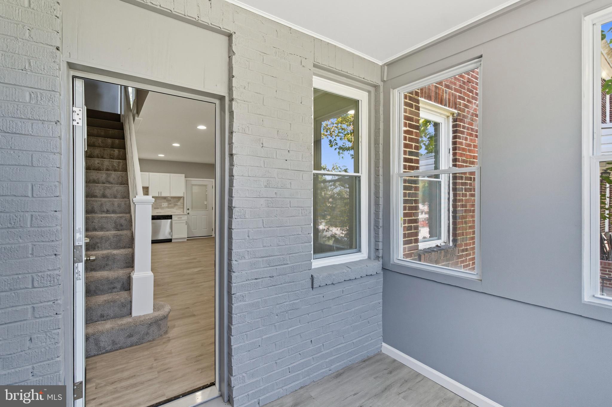 809 East Pontiac Avenue Baltimore, MD 21225 - Photo 3 of 36 an empty room with windows and entrance