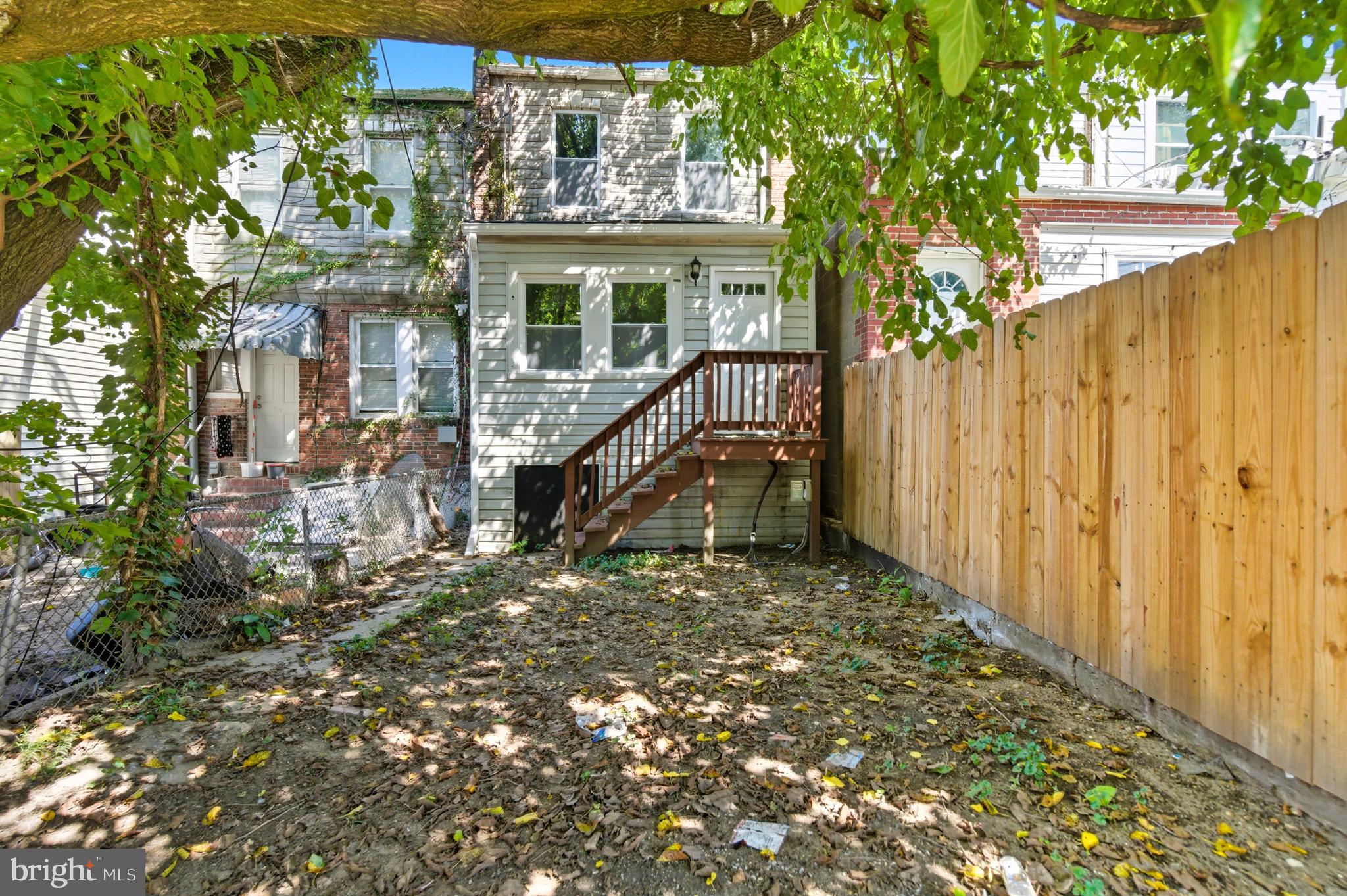 809 East Pontiac Avenue Baltimore, MD 21225 - Photo 33 of 36 a view of a house with a small yard and wooden fence