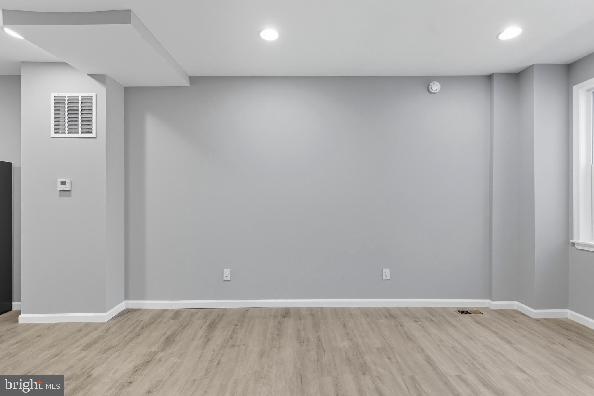 809 East Pontiac Avenue Baltimore, MD 21225 - Photo 7 of 36 a view of an empty room with wooden floor
