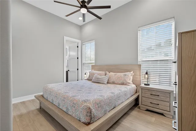 a bedroom with a bed chandelier and a window