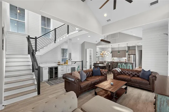 a living room with furniture and a chandelier