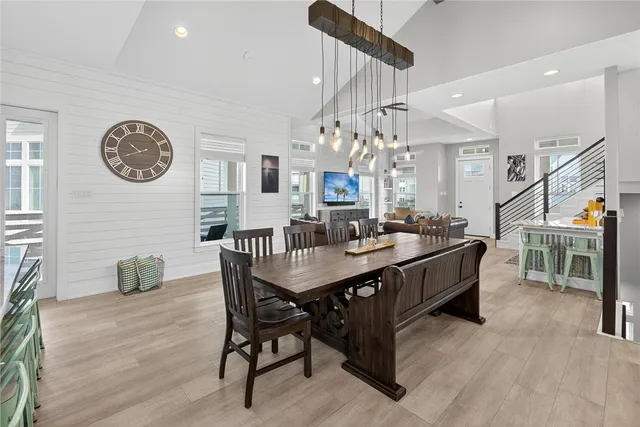 a view of a dining room with furniture and a chandelier