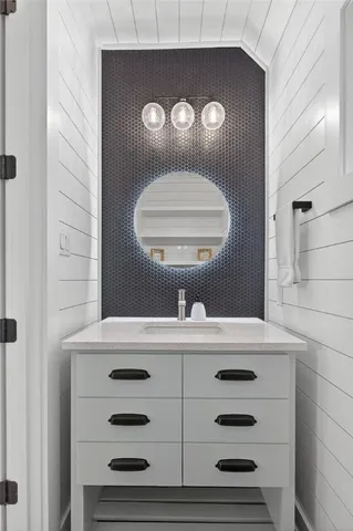 a bathroom with a sink a mirror and a toilet