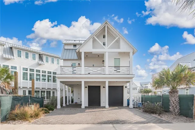 a view of white house with a yard