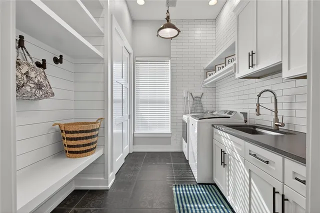 a kitchen with stainless steel appliances a stove a sink and cabinets
