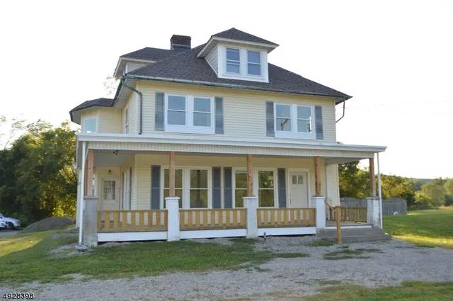 a house that has a big tree in front of it
