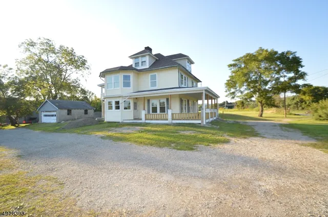 a front view of house with yard and trees