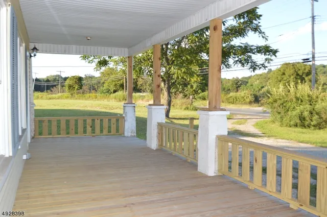 a view of a room with wooden floor and outdoor space