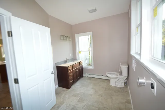 a spacious bathroom with a bathtub sink toilet and a window