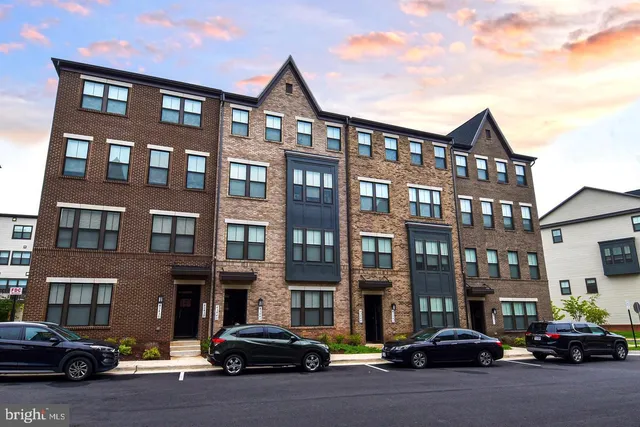 a couple of cars parked in front of brick building