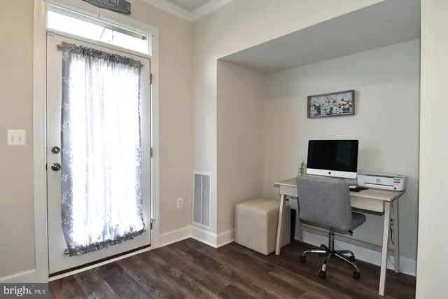 a kitchen with a table chairs refrigerator and microwave