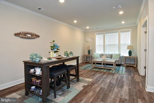 a living room with a couch and a coffee table with wooden floor