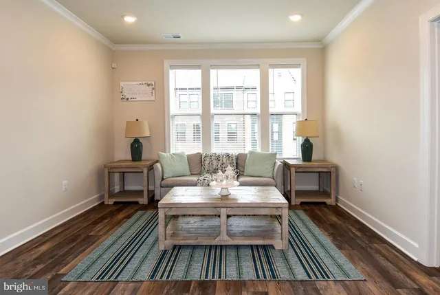 a view of a hallway with wooden floor and stairs