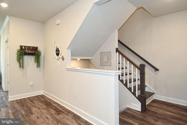 a large kitchen with kitchen island a stove a refrigerator a sink and a counter top space